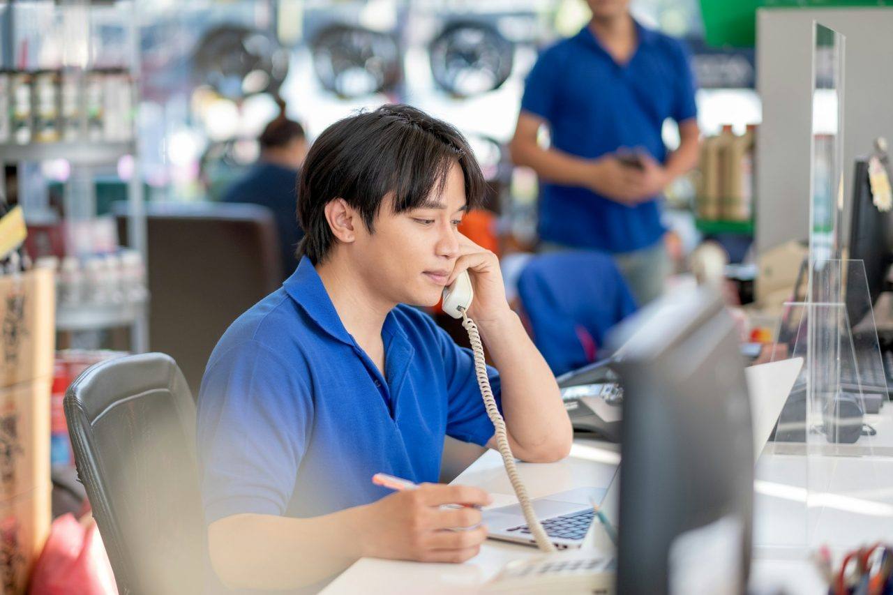 Store employee at a clean retail service counter