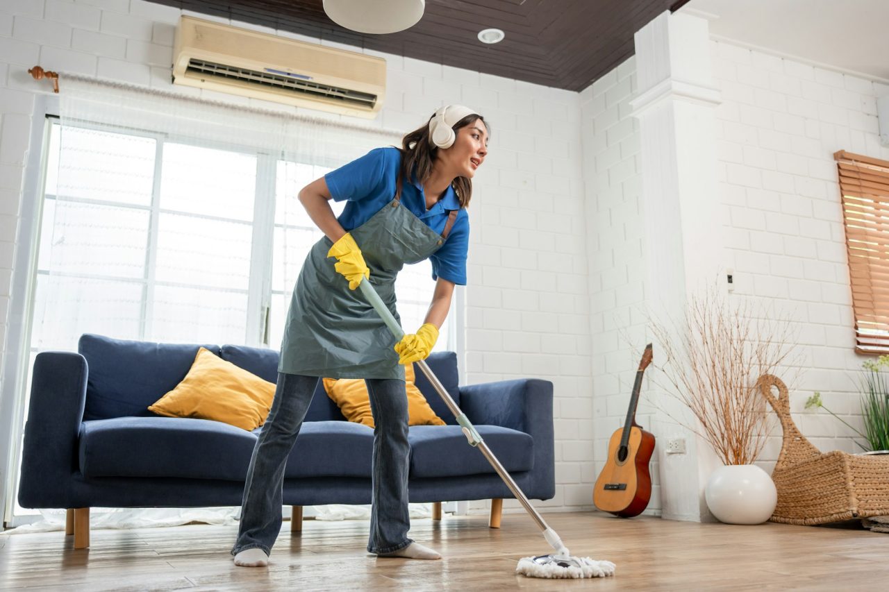 asian beautiful woman cleaner cleaning indoors in living room at home